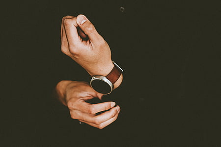 person holding his sleeve cuff
