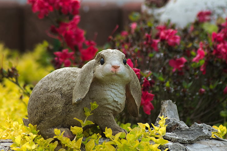 grey rabbit figurine in the garden