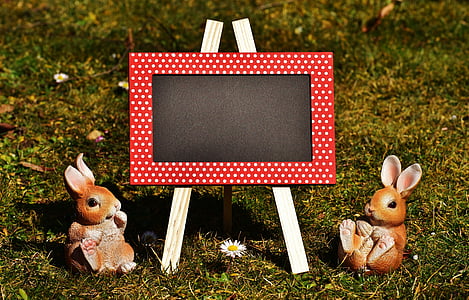 chalkboard and two rabbit figurines