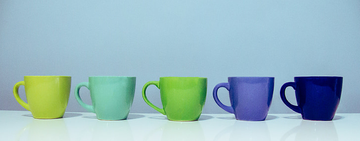 five assorted-color ceramic mugs