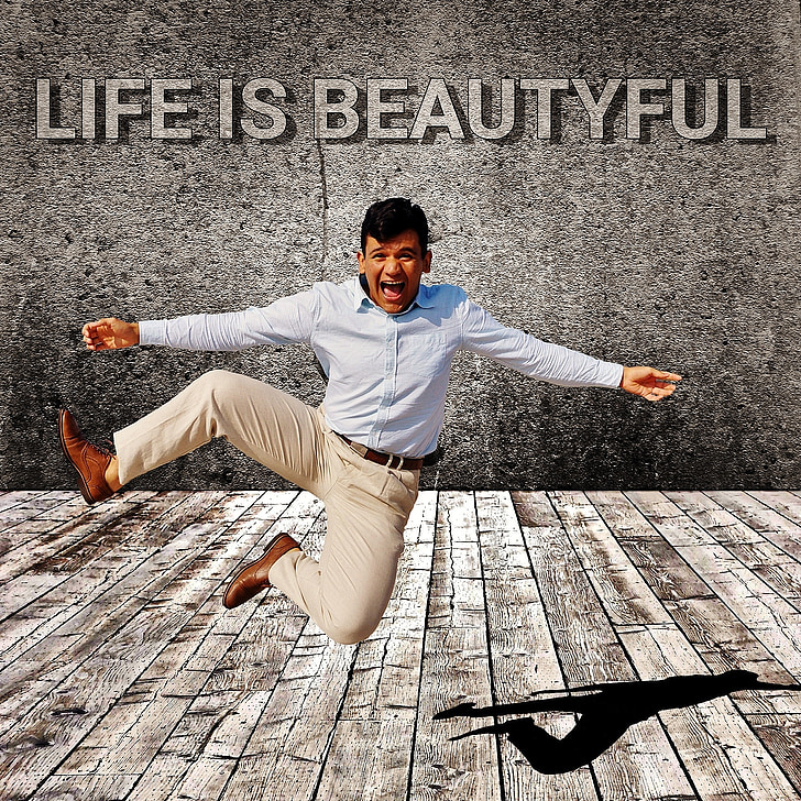 man in white dress shirt and brown dress pants jumping with Life is beautiful text overlay
