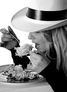grayscale photography of woman eating pasta