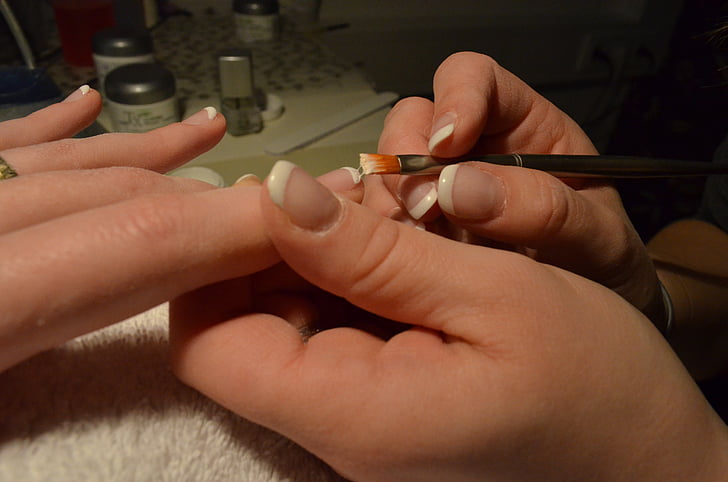 person holding nail polish brush