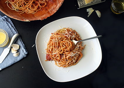 pasta with red sauce on white ceramic plate