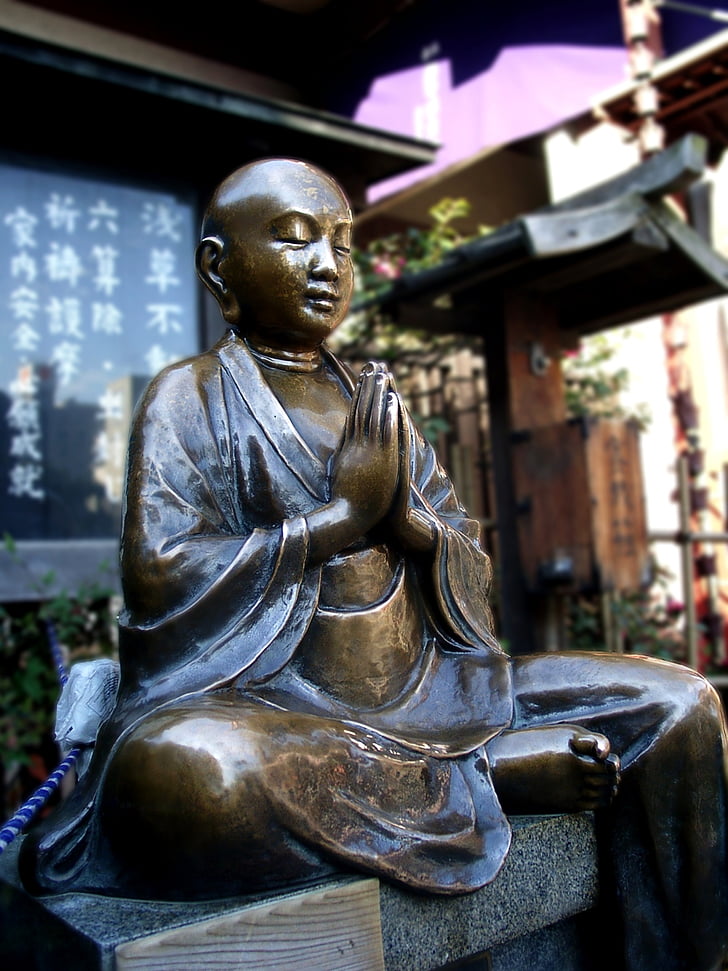 selective focus photograph Gautama Buddha statuette