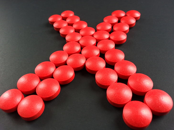 round red medication pill forming X