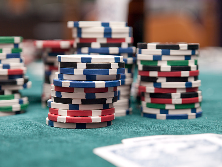 assorted poker chips on green surface