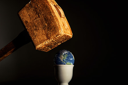 earth on top of white cup under brown mallet illustration