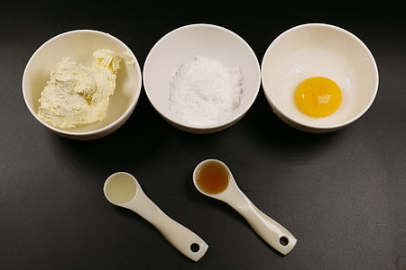 three white ceramic bowls with rice and eggs