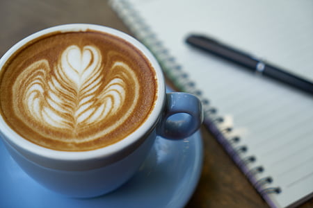 white ceramic cup filled with latte