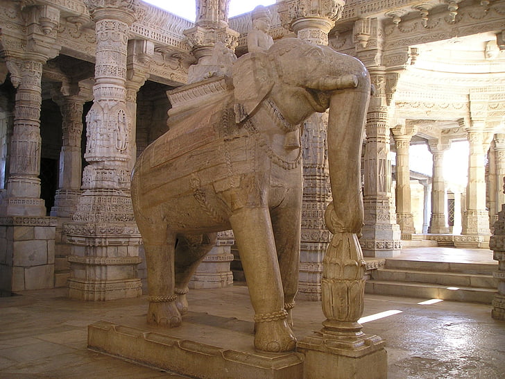 brown concrete elephant statue inside the temple