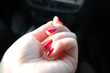 woman's hand with red manicure