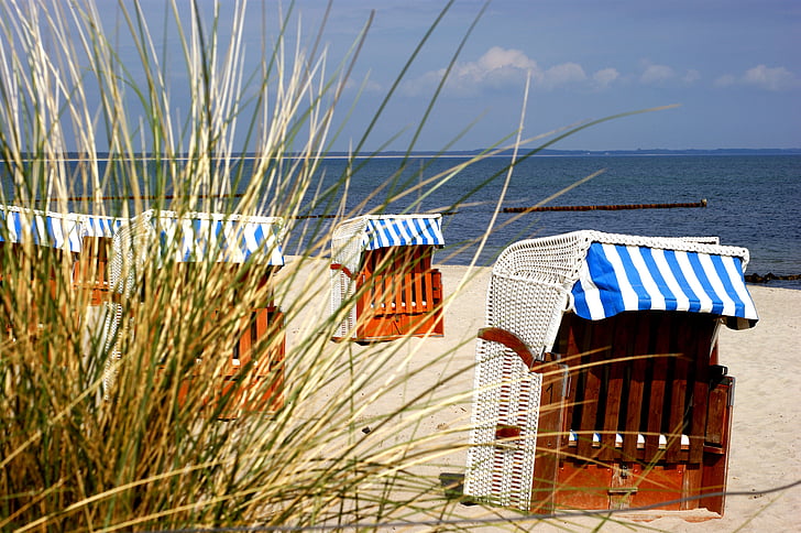 brown wooden stall on sand front of beach at daytime