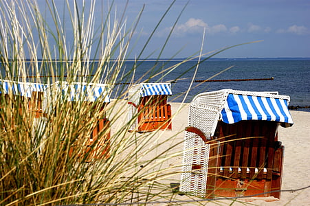 brown wooden stall on sand front of beach at daytime