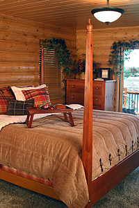rectangular brown wooden tray on brown comforter sheet inside bedroom