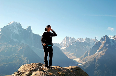 woman on gray top of the mountain during daytime