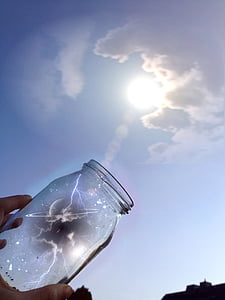 photography of jar reflecting on sun