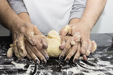 people rolling dough