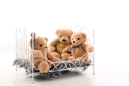 three life-size brown bear plush toys on bed