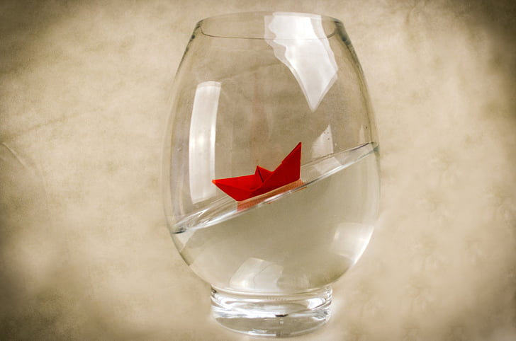clear glass with red origami inside