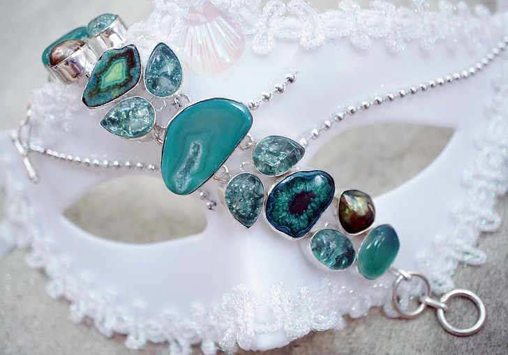 silver-colored jewelry with teal gemstones