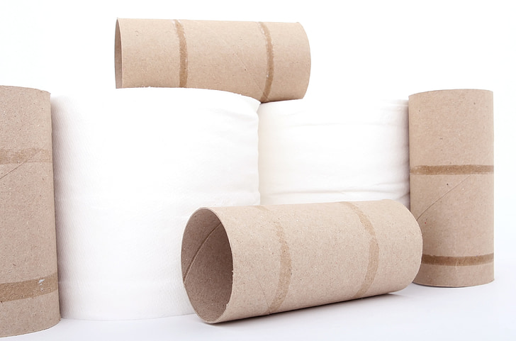 toilet paper and rolls on white surface