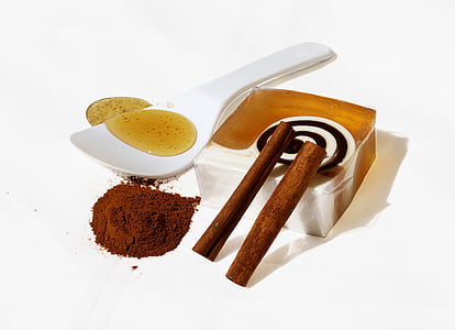honey, powder and box on white surface
