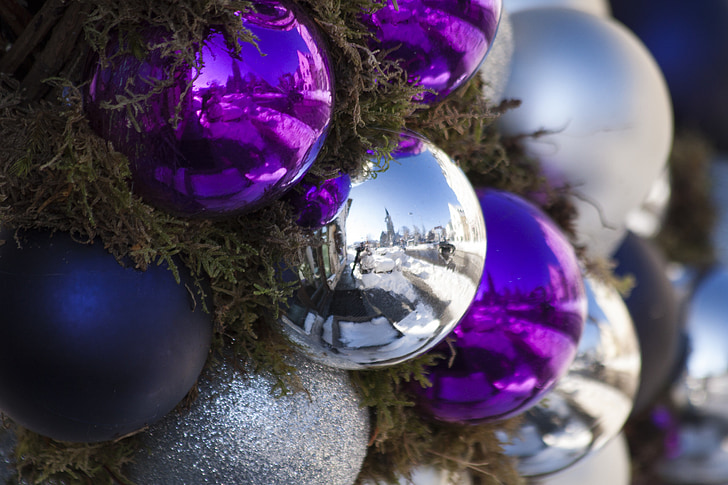 purple and gray Christmas baubles mounted on tree
