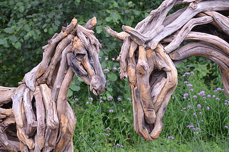 closeup photography of driftwood horse and calf decors