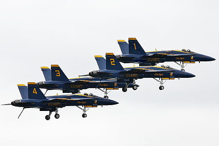 four flying blue jet planes