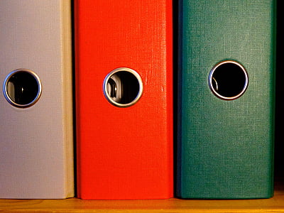three assorted-color piled cases