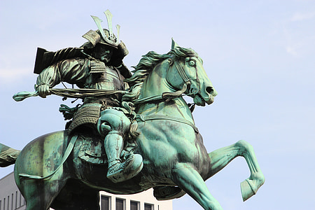 man riding on horse statuette