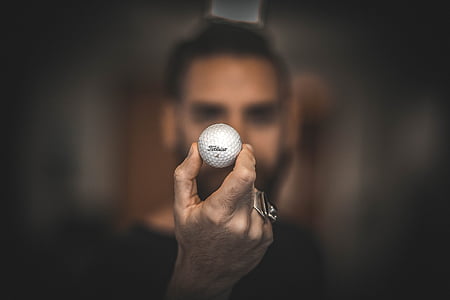 person holding golf ball