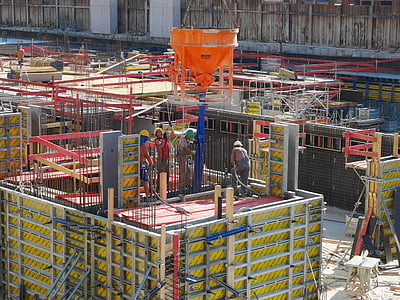 people working above yellow and red platform during daytime