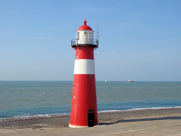 red and white lighthouse near shore