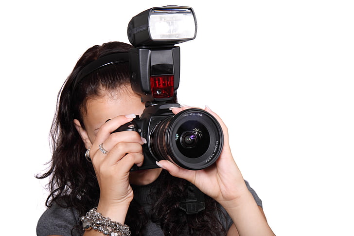 woman wearing black top holding black single-lens reflex camera