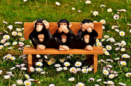 three wise monkeys sitting on bench figurine