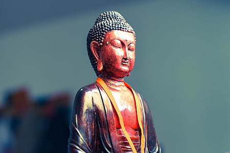 red and black Buddha figurine