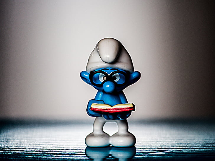 Brainy Smurf figurine on gray surface