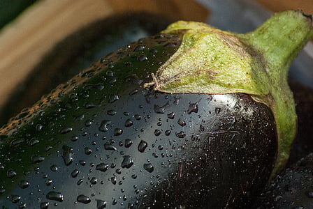 closeup photography of black and green eggplant