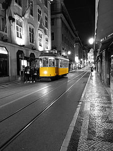 selective color photograph yellow and white tram