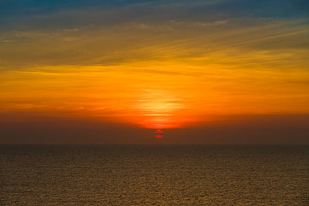 photo of sunset near body of water