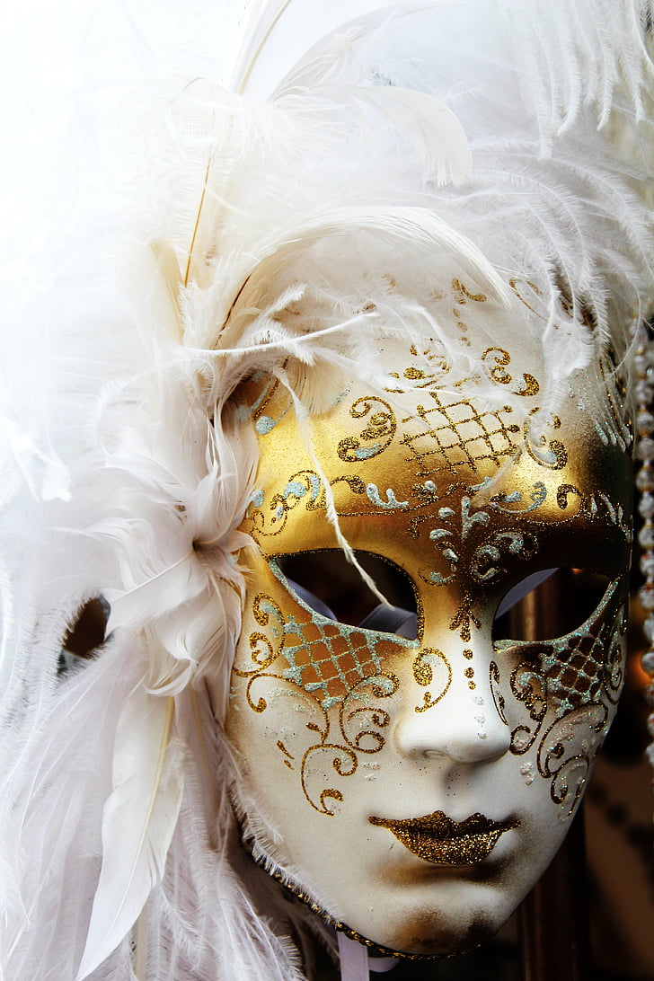 person wearing white and gold glittered cocktail mask