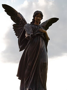 black female angel statue under cloudy sky during daytime