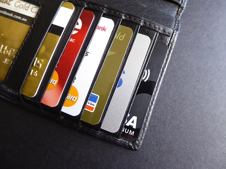 assorted-color cards on black leather wallet