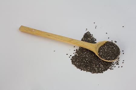 brown wooden spoon with black seeds