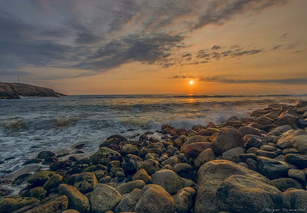 seawaves on rocks during golden hour
