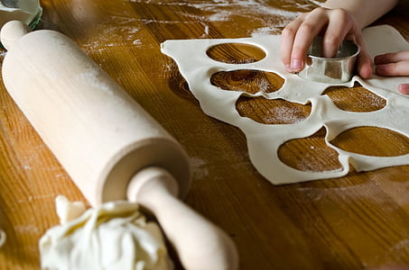 rolling pin and dough on wooden table