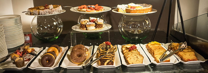 varieties of food on plates and trays on display