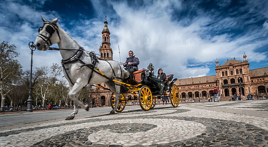 people riding on carriage in front of church during daytime